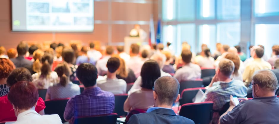 A person presenting in front of an audience